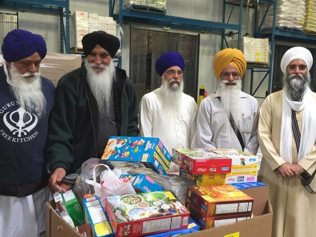 Temple leaders with the food items before the three trucks were dispatched.
