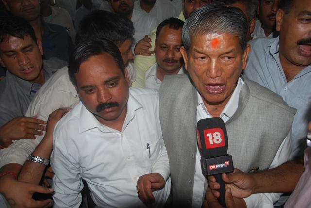 Former CM Harish Rawat with BJP MKA Bhim Lal Arya after floor test outside the assembly in Dehradun. (Vinay Santosh Kumar)