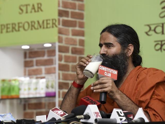 Patanjali Ayurved patron and yoga guru Baba Ramdev shows the company’s FMCG and aurveda products at a press conference in New Delhi on April 26, 2016. Well-entrenched FMCG companies are having to rethink their strategy due to Patanjali’s commercial success(Hindustan Times file photo) Patanjali Ayurved patron and yoga guru Baba Ramdev shows the company’s FMCG and aurveda products at a press conference in New Delhi on April 26, 2016. Well-entrenched FMCG companies are having to rethink their strategy due to Patanjali’s commercial success(Hindustan Times file photo)