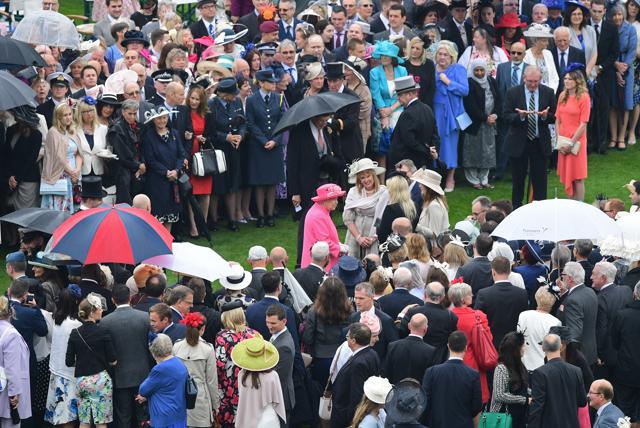 Queen Elizabeth II talks with guests at a garden party at Buckingham Palace in London on Tuesday . Every summer, the Queen hosts at least three such parties at Buckingham Palace and are attended by people from all walks of life. Garden parties have been held at the palace since the 1860s. (AP) Queen Elizabeth II talks with guests at a garden party at Buckingham Palace in London on Tuesday . Every summer, the Queen hosts at least three such parties at Buckingham Palace and are attended by people from all walks of life. Garden parties have been held at the palace since the 1860s. (AP)