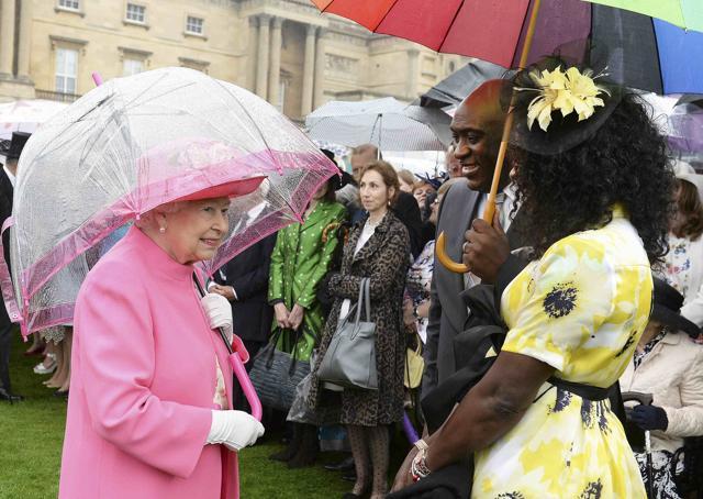 Queen Elizabeth II speaks to Pastor Kofi Banful and Jayne Banful in the garden of Buckingham Palace, as up to 8,000 guests attend the first royal garden party of the year, in London on Tuesday. (REUTERS) Queen Elizabeth II speaks to Pastor Kofi Banful and Jayne Banful in the garden of Buckingham Palace, as up to 8,000 guests attend the first royal garden party of the year, in London on Tuesday. (REUTERS)