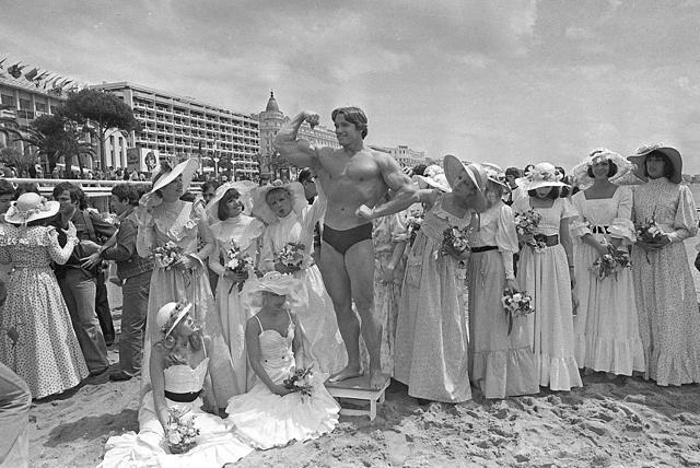 In this May 20, 1977 file photo, Arnold Schwarzenegger shows off his body for an appreciative beach audience in Cannes, France, ahead of the presentation of his film Pumping Iron at the Cannes Film Festival. (AP) In this May 20, 1977 file photo, Arnold Schwarzenegger shows off his body for an appreciative beach audience in Cannes, France, ahead of the presentation of his film Pumping Iron at the Cannes Film Festival. (AP)