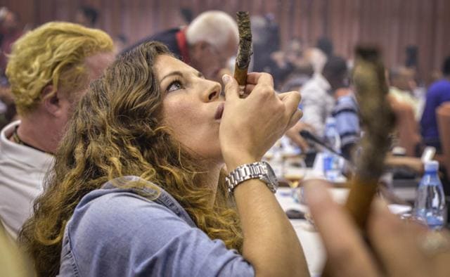 A woman smokes a cigar during the contest for the longest ash, at the XVI Havana Cigar Festival, in the Cuban capital on February 27, 2014. (AFP) A woman smokes a cigar during the contest for the longest ash, at the XVI Havana Cigar Festival, in the Cuban capital on February 27, 2014. (AFP)