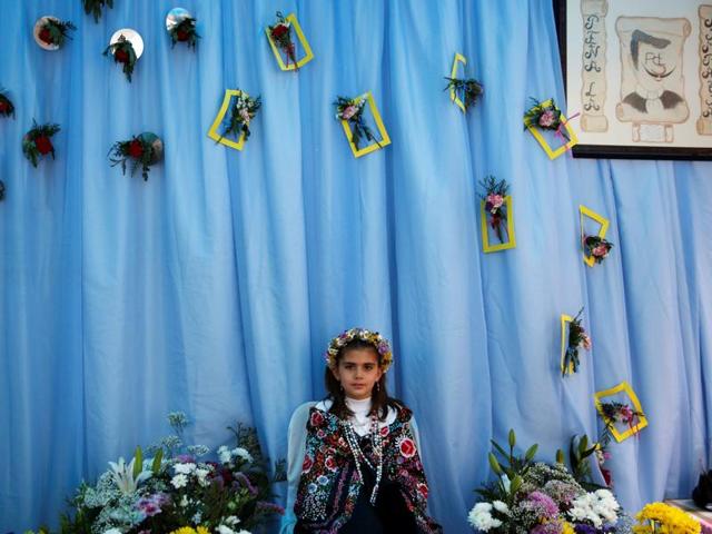 The tradition got lost over time, but it returned in the mid-eighties. Maya girl Sara Prieto Aparicio, 9, sits at an altar. (REUTERS)