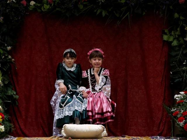 This year the rain forced the Mayas to share an altar indoors, after the ones built on the streets got too wet. Maya girl Ines de la Paloma, 9, (L), sits with her friend Nuria Sanchez Caballero, 6, at an altar. (REUTERS)