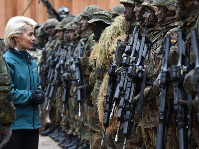 This file photo shows German defence minister Ursula von der Leyen (C) posing with mountain infantry soldiers.(AFP)