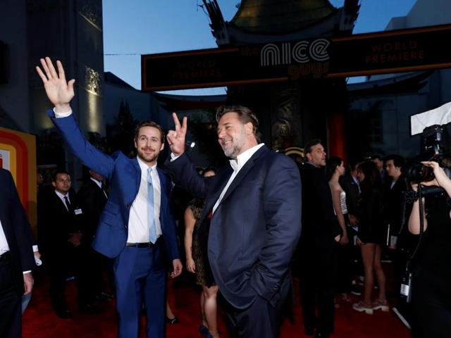 Ryan Gosling and Russell Crowe wave at fans at the premiere of The Nice Guys in Hollywood. (REUTERS)