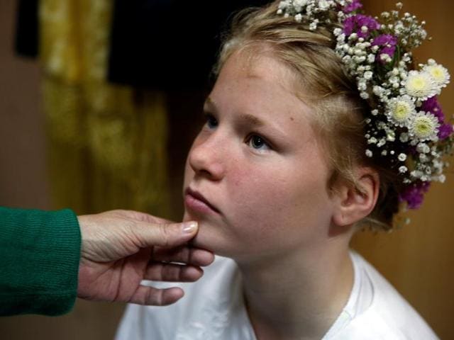Marina Guerrero, 10, gets dressed to become a Maya for the festival. (REUTERS)