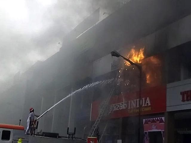 Firemen at work at Aakash Institute in Sector 14, Panchkula, on Wednesday morning. (Sant Arora/HT Photo)