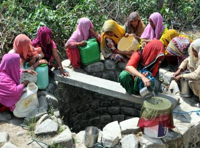 A woman filters water after collecting it from a nearly dried up well at Padal village of Samba district,  40 km from Jammu, on April 27, 2016. (Nitin Kanotra / Hindustan Times)