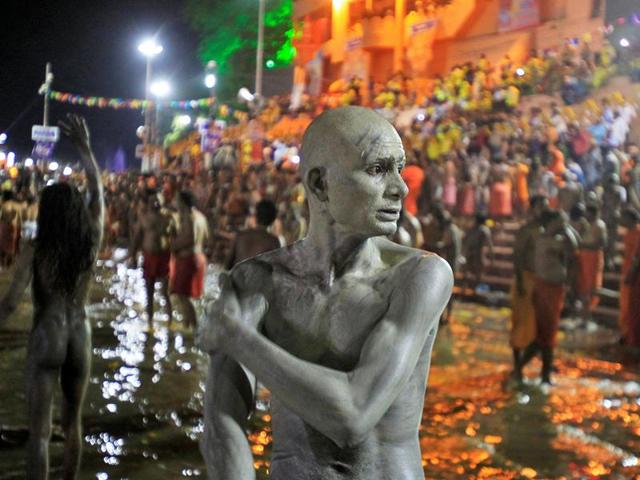 A Sadhu applies ashes on his body after taking a dip in the waters of Shipra river during the second 'Shahi Snan' (grand bath) at the Simhastha Kumbh Mela in Ujjain. (REUTERS) 