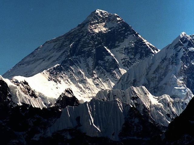 Light illuminates Mount Everest (C) during sunset in Solukhumbu district, also known as the Everest region, in this picture taken November 30, 2015. Nine Nepalis reached the top of Mount Everest on Wednesday, the first group of climbers to summit the world’s highest mountain in three years after deadly disasters forced a shutdown.(AP)