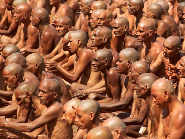 Newly initiated Naga Sadhus perform Pinda Daan, a ritual on the banks of Shipra river during Simhastha Kumbh Mela in Ujjain. (REUTERS) 