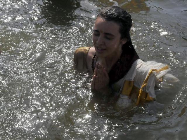 A sadhvi takes a holy dip at Dutt Akhada ghat during Simhastha Kumbh in Ujjain. (Arun Mondhe/ Hindustan Times) 
