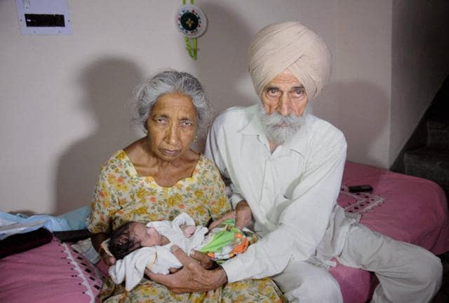Proud parents Mohinder Singh Gill (right), 79, and his wife Daljinder Kaur, 70, pose as they hold their newborn Arman at their home in Amritsar.(PTI)