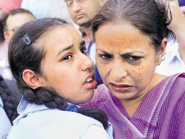 File photo of a woman and daughter crying after coming out of the library on April 12. (Bharat Bhushan/HT Photo) File photo of a woman and daughter crying after coming out of the library on April 12. (Bharat Bhushan/HT Photo)