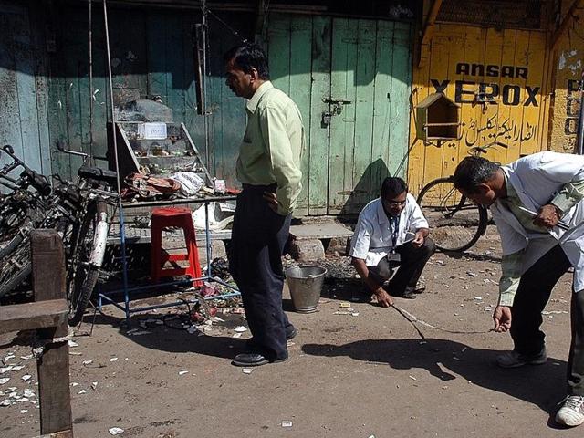 Forensic experts search for clues at the blast site in Maharashtra’s Malegaon on September 30, 2008. (AFP) Forensic experts search for clues at the blast site in Maharashtra’s Malegaon on September 30, 2008. (AFP)