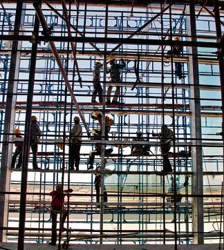 Indian labourers put sheets of glass in place of a new terminal bulding at the GMR Hyderabad International Airport (AFP) Indian labourers put sheets of glass in place of a new terminal bulding at the GMR Hyderabad International Airport (AFP)