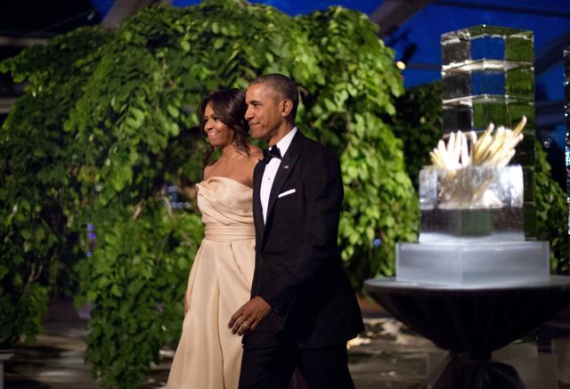 US President Barack Obama and first lady Michelle Obama walk in as they are introduced during a state dinner. (AP Photo)