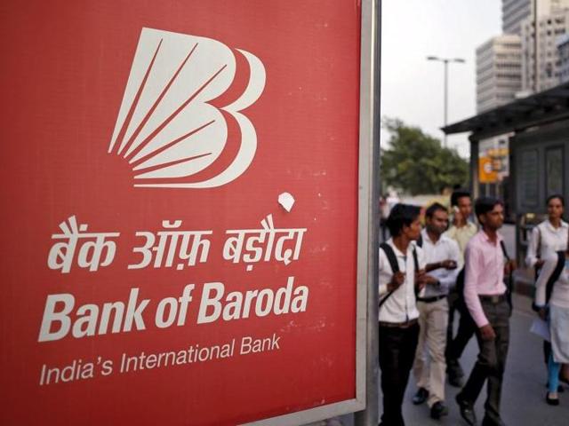 Commuters walk past an advertisement of Bank of Baroda on a busy street in New Delhi. (REUTERS FILE) Commuters walk past an advertisement of Bank of Baroda on a busy street in New Delhi. (REUTERS FILE)