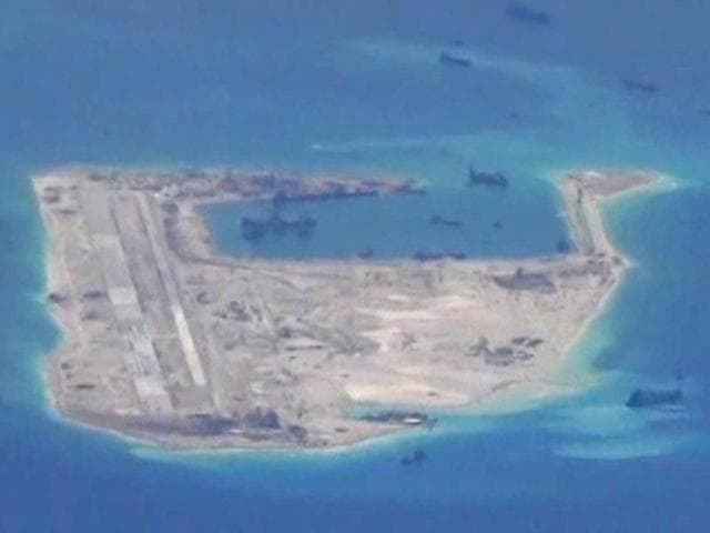 Chinese dredging vessels are purportedly seen in the waters around Fiery Cross Reef in the disputed Spratly Islands in the South China Sea in this still image taken by a US surveillance aircraft.(Reuters Photo)