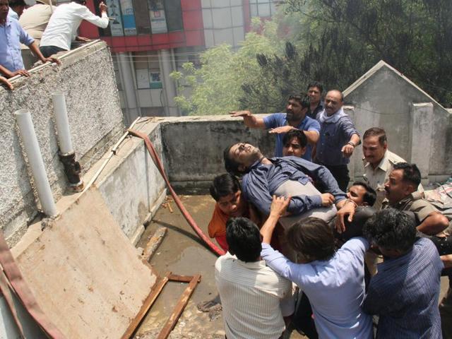 Local residents help rescue 11 employees of Indiamart who were stuck on the second floor of the building that caught fire on Saturday morning. The residents climbed to the roof of an adjacent building and used a ladder to reach the employees. One of them, Piyush Goel, who tried to jump over to the other building, missed and fell to his death. (Sakib Ali /Hindustan Times) Local residents help rescue 11 employees of Indiamart who were stuck on the second floor of the building that caught fire on Saturday morning. The residents climbed to the roof of an adjacent building and used a ladder to reach the employees. One of them, Piyush Goel, who tried to jump over to the other building, missed and fell to his death. (Sakib Ali /Hindustan Times)