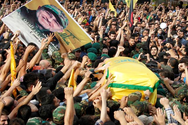 Hezbollah members carry the coffin and a picture of Badreddine. (REUTERS) Hezbollah members carry the coffin and a picture of Badreddine. (REUTERS)