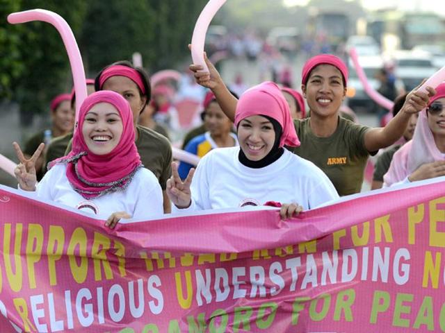 In this file photo, Muslim women hold a banner as they run during an event called Hijab Run for Peace Religious Understanding Now at the People Power Monument in Manila in 2012. (AFP) In this file photo, Muslim women hold a banner as they run during an event called Hijab Run for Peace Religious Understanding Now at the People Power Monument in Manila in 2012. (AFP)