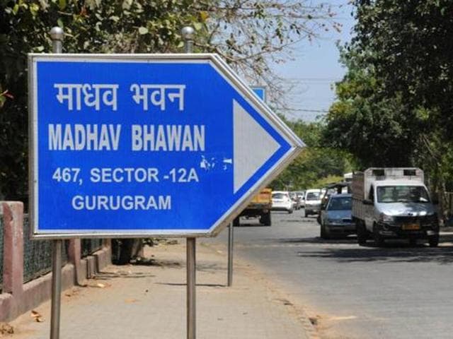 A sign board showing Gurugram mentioned in the address of RSS office in Gurgaon.(Parveen Kumar//HT file photo)