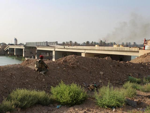 A fighter from the Iraqi pro-government forces looks towards the Albu Aitha bridge north of Ramadi following an attack a military source said was carried out by the Islamic State (IS) group. (AFP) A fighter from the Iraqi pro-government forces looks towards the Albu Aitha bridge north of Ramadi following an attack a military source said was carried out by the Islamic State (IS) group. (AFP)