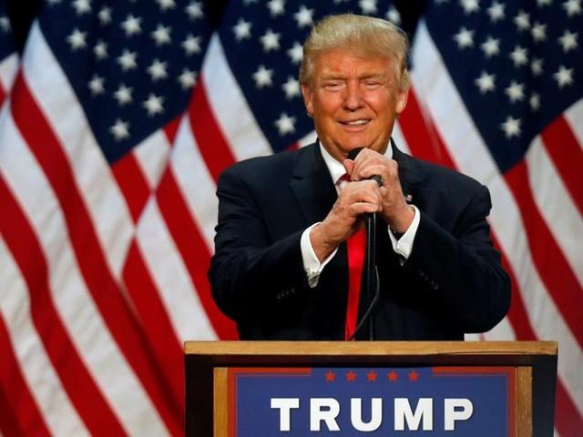 Donald Trump points to a supporter as he leaves a campaign event in an airplane hangar in Rome.(REUTERS)