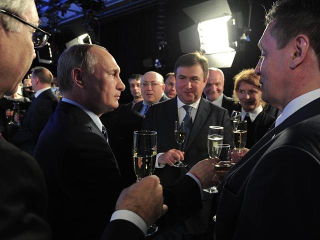 Russian President Vladimir Putin, second left, congratulates the staff of the Sochi state radio and TV company as the VGTRK state-owned media as it celebrates its 25th anniversary, in Sochi, Russia, on Friday. (AP) Russian President Vladimir Putin, second left, congratulates the staff of the Sochi state radio and TV company as the VGTRK state-owned media as it celebrates its 25th anniversary, in Sochi, Russia, on Friday. (AP)