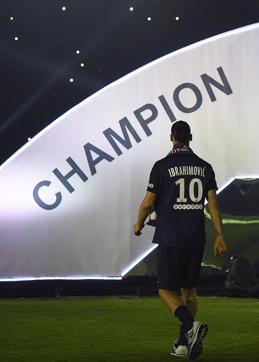 Swedish forward Zlatan Ibrahimovic arrives on the podium after winning the French L1 title. (AFP Photo)