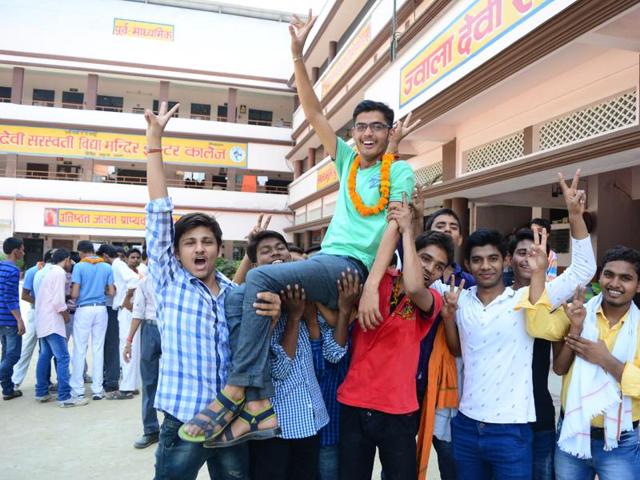 Students in Allahabad show the sign of victory after the results were declared. (Sheeraz Rizvi/HT photo)