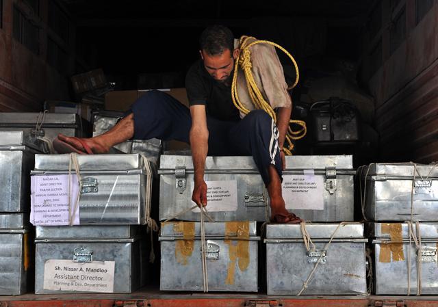 A labourer is adjusting boxes containing official records of Jammu and Kashmir states' civil secretariat, for loading them into the trucks. (Nitin Kanotra / HIndustan Times) A labourer is adjusting boxes containing official records of Jammu and Kashmir states' civil secretariat, for loading them into the trucks. (Nitin Kanotra / HIndustan Times)