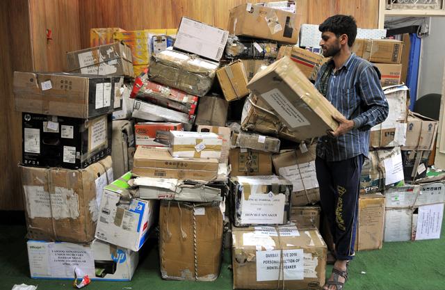A labourer is adjusting boxes containing official records of Jammu and Kashmir states' civil secretariat, for loading them into the trucks. (Nitin Kanotra / HIndustan Times) A labourer is adjusting boxes containing official records of Jammu and Kashmir states' civil secretariat, for loading them into the trucks. (Nitin Kanotra / HIndustan Times)