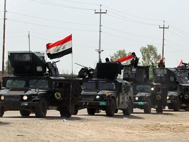 Members of Iraq's anti-terror brigade are seen on a road between Baghdad and Samarra, as they make their way to the Balad area, north of the capital Baghdad. (AFP) Members of Iraq's anti-terror brigade are seen on a road between Baghdad and Samarra, as they make their way to the Balad area, north of the capital Baghdad. (AFP)