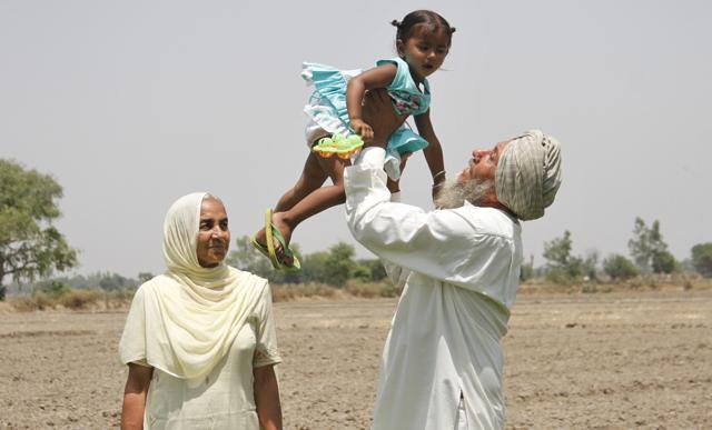 The arms are sore, but holding baby Manwinder lifts Darbara Singh’s heart. Mother Jasmail knows. (JS Grewal/HT Photo) The arms are sore, but holding baby Manwinder lifts Darbara Singh’s heart. Mother Jasmail knows. (JS Grewal/HT Photo)