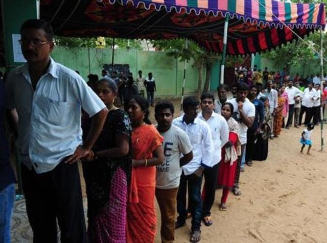 Voters wait for their turn to cast their ballots at a polling station in Chennai.(AFP)