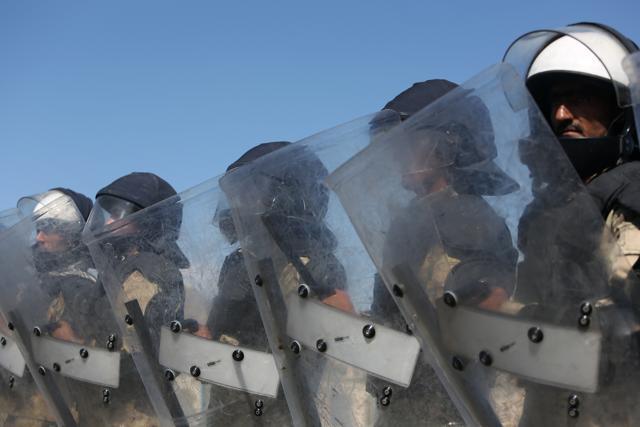 Afghan police block a road in Kabul for a massive protest march by members of an ethnic minority group over the proposed route of a power line on Monday, May 16, 2016. (AP)