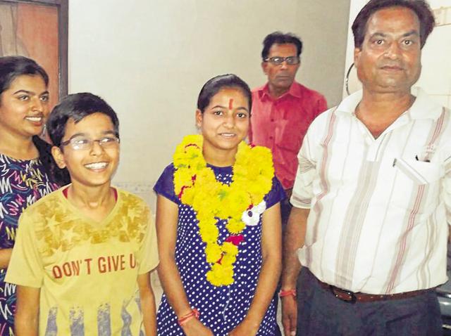 Niyati Saxena is all smiles after becoming state topper from science stream.(HT Photo)