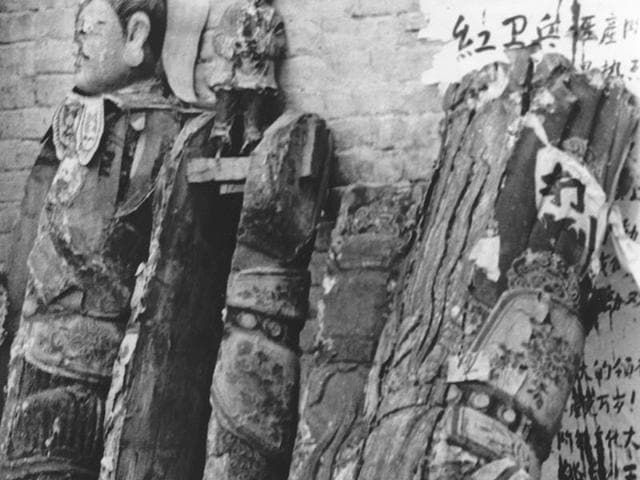 Religious sculptures lean against the wall of a suburban Beijing Buddhist temple after being ripped from their pedestals by Red Guards, infused by Communist Party chairman Mao Zedong's calls to root out vestiges of old Chinese culture. (AP File Photo)