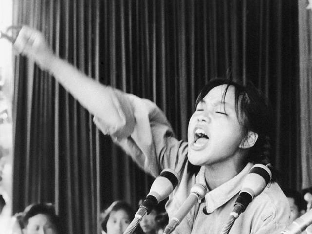 A young woman identified only as Ms. Zhou calls out to embolden her fellow Red Guards in Beijing's Tiananmen Square at the start of the 1966-76 Cultural Revolution. (AP File Photo)