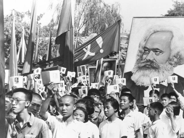 Children are seen at a rally during the height of the Red Guard upheaval, waving copies of the collected writings of Communist Party chairman Mao Zedong, often referred to as Mao's Little Red Book, and carrying a poster of Karl Marx. (AP File Photo)