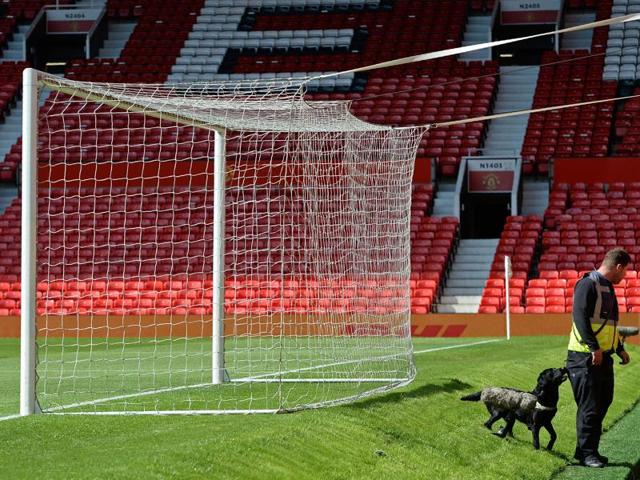 A sniffer dog searches the stands after fans evacuated Old Trafford stadium in Manchester, England, on May 15, 2016, after the Premier League match between Manchester United and Bournemouth was abandoned. (AFP) A sniffer dog searches the stands after fans evacuated Old Trafford stadium in Manchester, England, on May 15, 2016, after the Premier League match between Manchester United and Bournemouth was abandoned. (AFP)