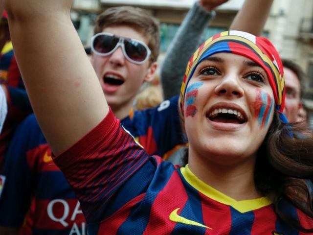 A Barcelona fan cheers the team. (AFP)