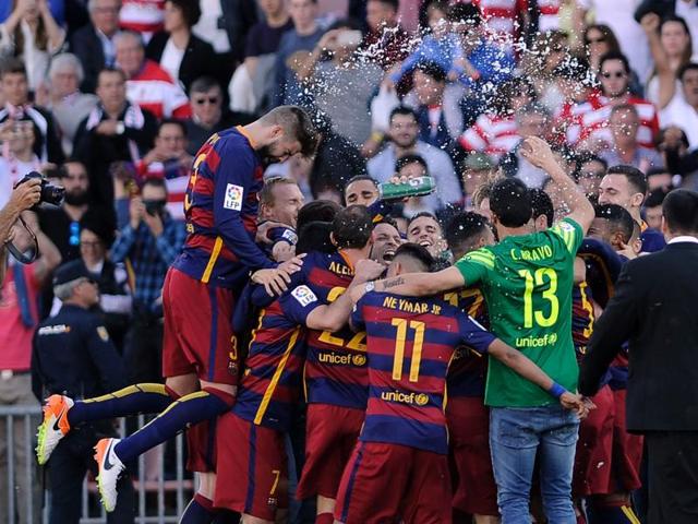 Barcelona's players celebrate their 24th La Liga title at the end of the match against Granada. (AFP)