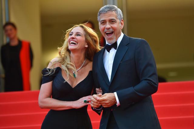 US actors Julia Roberts and George Clooney react as they arrive for the screening of their film Money Monster at the 69th Cannes Film Festival in Cannes. (AFP) US actors Julia Roberts and George Clooney react as they arrive for the screening of their film Money Monster at the 69th Cannes Film Festival in Cannes. (AFP)