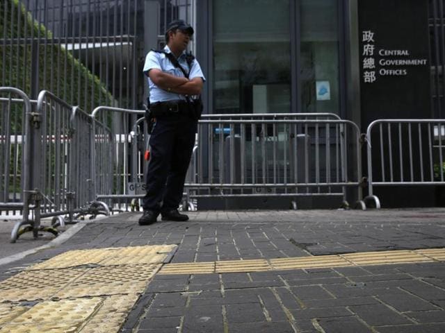 A policeman stands on pavement reinforced with glue to prevent the bricks from being dug up and used as projectiles during expected protests outside the central government offices in downtown Hong Kong. (AFP Photo) A policeman stands on pavement reinforced with glue to prevent the bricks from being dug up and used as projectiles during expected protests outside the central government offices in downtown Hong Kong. (AFP Photo)