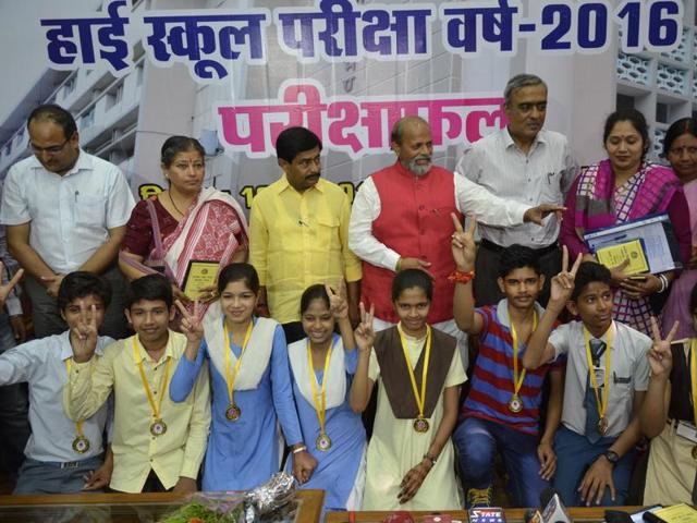 Education minister Paras Jain felicitating MP board high school examination topper Mukesh Chandel in Bhopal on Monday. (Mujeeb Faruqui/ HT photo) Education minister Paras Jain felicitating MP board high school examination topper Mukesh Chandel in Bhopal on Monday. (Mujeeb Faruqui/ HT photo)